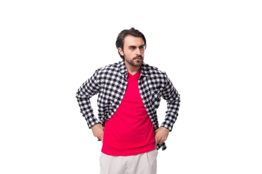 young european man with black hair and unshaven beard in a shirt on a white background with copy space.