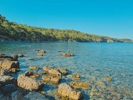 beautiful view of the rocky beach and blue clear sea water. summer holiday concept. summer card