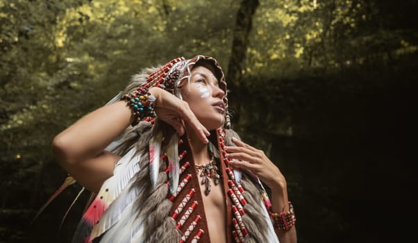 portrait of a young girl in Native American Headdresses against the background of nature