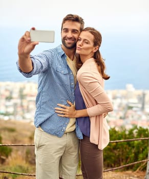 Couple, hug and selfie on vacation, phone and outdoors on adventure, love and memories for social media. Happy people, smartphone and bonding or technology, travel and holiday or pout on date.