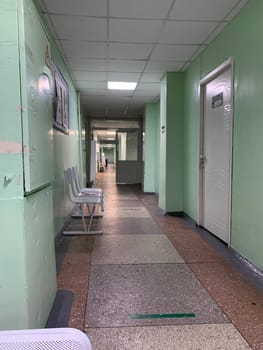 11.13.2023, Kemerovo, Russia. Empty corridor of an old hospital. hospital corridor with offices, old hospital, scary atmosphere