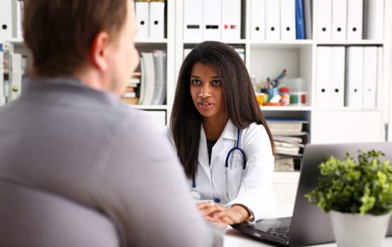 Friendly female doctor hold male patient hand in office during reception. Examination result positive test calm down promise and cheer up grief and suffer treatment condolence ethics concept