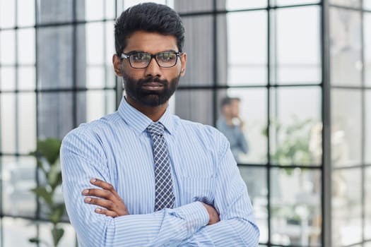 male investor beard looking at camera and smiling in modern office