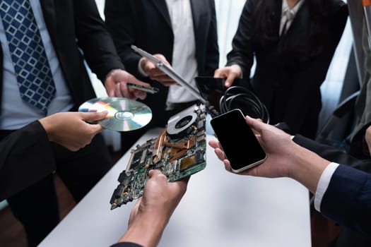 Business people holding electronic waste as eco-business recycle waste policy in corporate responsibility. Reuse, reduce and recycle for sustainability environment. Quaint