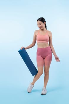 Young attractive asian woman portrait in sportswear with exercising mat. Healthy exercise and workout routine lifestyle concept. Studio shot isolated background. Vigorous