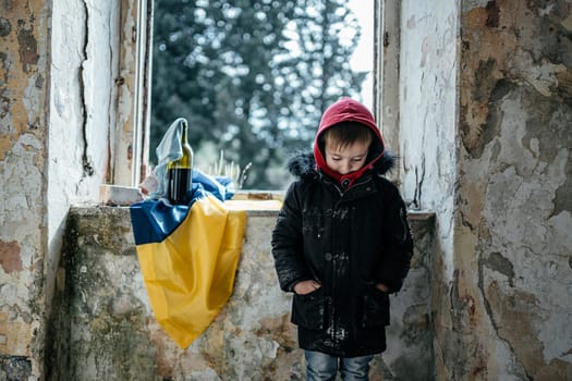 Little Boy in a Ruined House War in Ukraine. Ukrainian flag. High quality photo
