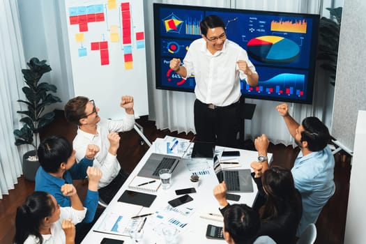 Excited and happy office worker employee celebrate after make successful strategic business marketing planning. Teamwork and positive attitude create productive and supportive workplace. Prudent