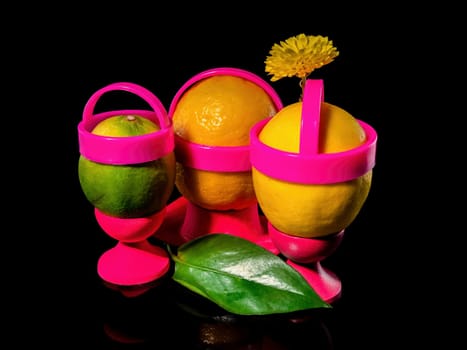 Creative still life with three lemons on a black background