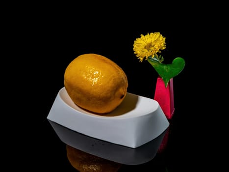 Creative still life with lemon bathing on a black background