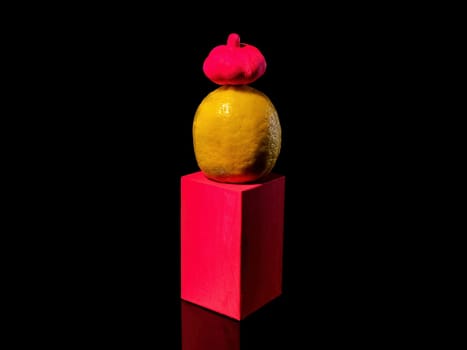 Creative still life Composition with lemon on a stand on a black background