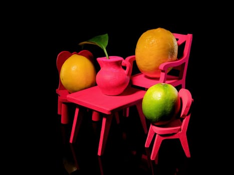 Creative still life with three lemons at the empty table on a black background