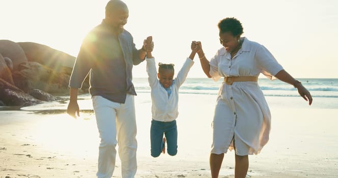 Parents, holding hands and swing child on beach for vacation, holiday and fun game at sunset. Happy family, play and relax together at the sea, ocean and playing on sand with trust, support and care.