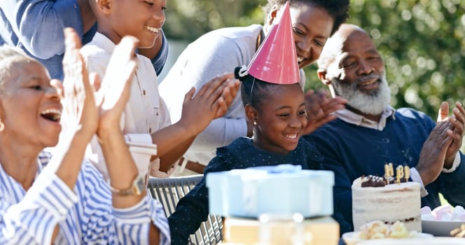 Child, grandparents or black family in backyard for a happy birthday, celebration or growth together. Smile, clapping or excited African people with cake, love or kids in a fun party, nature or park.