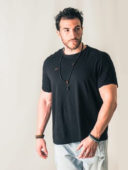 A man in a black shirt is posing for a picture, on white background