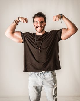 A Confident Man Doing a Double Biceps Pose, Smiling to the Camera, on white background