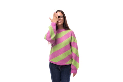 pretty beautiful young european brunette woman with vision glasses dressed in casual striped pink green pullover.