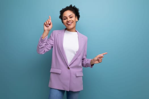 young positive cheerful hispanic business woman with curly hair dressed in an office stylish jacket.