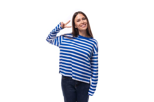 beautiful young brunette woman with long hair in a striped blue blouse on a white background with copy space.