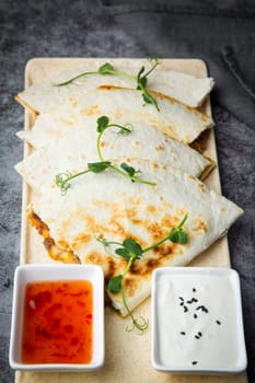 chicken quesadilla with herbs sauce and sour cream