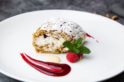 sweet sponge dessert with raspberries and powdered sugar