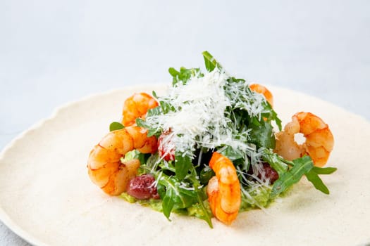 beautifully served shrimp with arugula and grated cheese