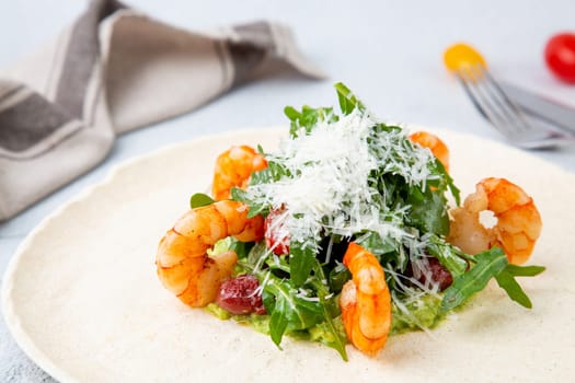 beautifully served shrimp with arugula and grated cheese