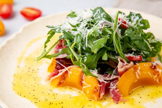 green salad with arugula and lingonberries on a white plate and marble background