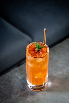 tropical cocktail with sunset gradient and citrus