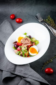 salad with soft-boiled egg, tuna, green onions, boiled potatoes