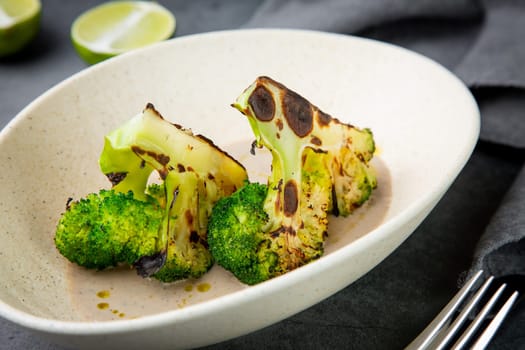 baked broccoli in mushroom sauce on a white plate