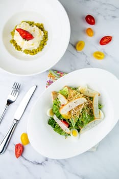 salad with quail eggs, cherry tomatoes, lettuce and breadcrumbs