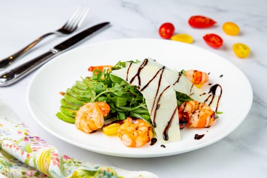 shrimp with avocado slices and arugula with teriyaki sauce