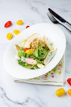 salad with quail eggs, cherry tomatoes, lettuce and breadcrumbs