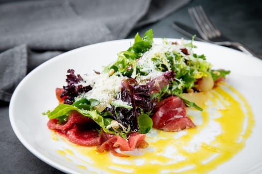 side view of salad with red fish, herbs and cheese