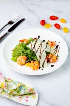 shrimp with avocado slices and arugula with teriyaki sauce