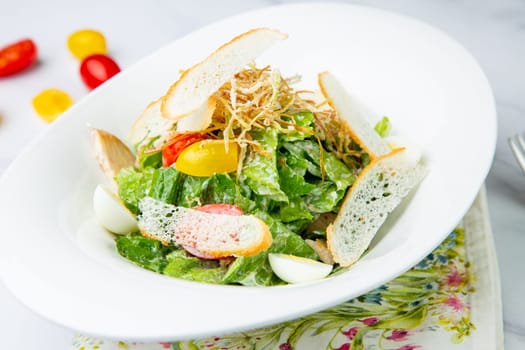 salad with quail eggs, cherry tomatoes, lettuce and breadcrumbs