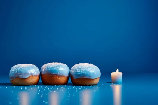 Hanukkah donuts with powdered sugar on a blue background. The concept and background of the Jewish holiday of Hanukkah. A place to copy. High quality photo