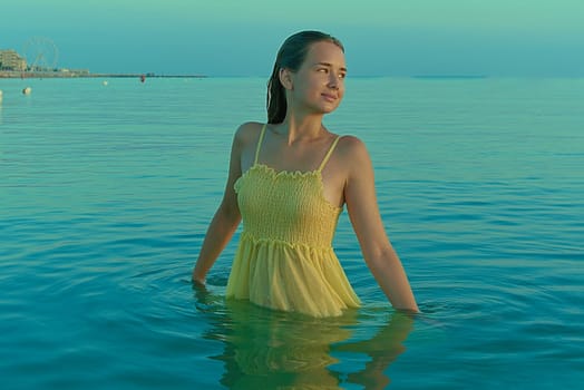 Beautiful sexy stylish Caucasian young woman model on the sea beach at sunrise