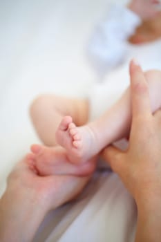 Baby, feet and hand for protection in bedroom with closeup for safety, security and care. Person, parent and bond with infant for love, support and hope for new life, development or future in home.