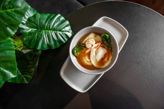 Asian wonton soup with dumplings and pak choi cabbage. High quality photo