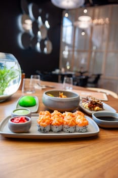 Sushi roll with salmon tartare and sesame seeds on a plate close-up. High quality photo