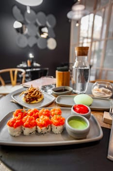 Sushi roll with salmon tartare and sesame seeds on a plate close-up. High quality photo