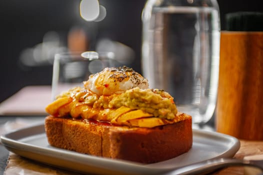 Croque Madame - hot french sandwich with ham, melted cheese, fried egg and sauce with salad. Delicious breakfast. High quality photo