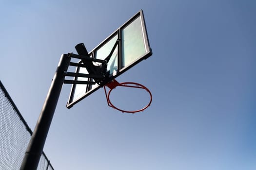 Streetball ring outdoor. Blue sky as background and copy space. Urban youth game.