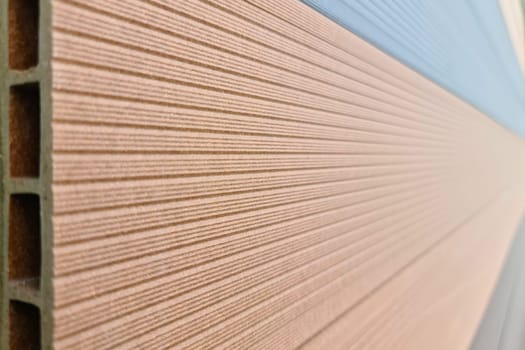WPC terrace board, wood plastic composite decking boards in hardware store, close-up.