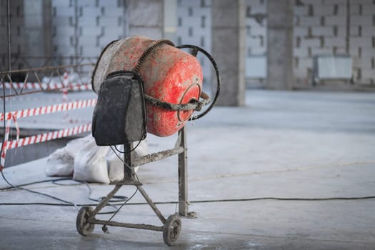 Electric concrete mixer at a construction site, copy space.