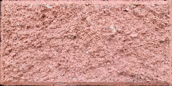 Texture of a large red street brick concrete block with a chamfer.