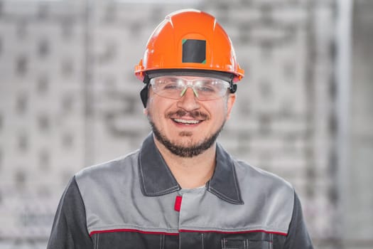 Construction worker portrait, caucasian man in hard hat, protective glasses and uniform, building and inspection.
