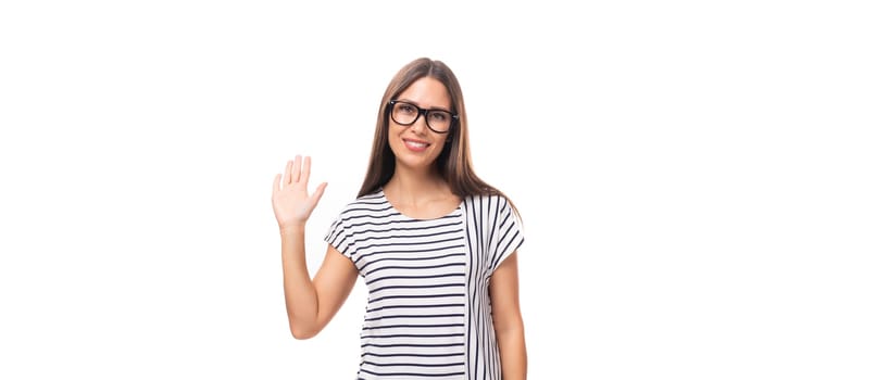 portrait of a young cute casual european woman with long dark hair dressed in a striped t-shirt on a white background with copy space.