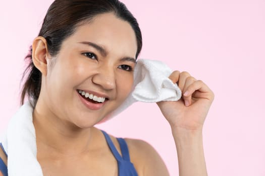 Athletic and sporty asian woman resting after intensive cardio workout training. Healthy exercising and fit body care lifestyle pursuit in studio shot isolated background. Vigorous